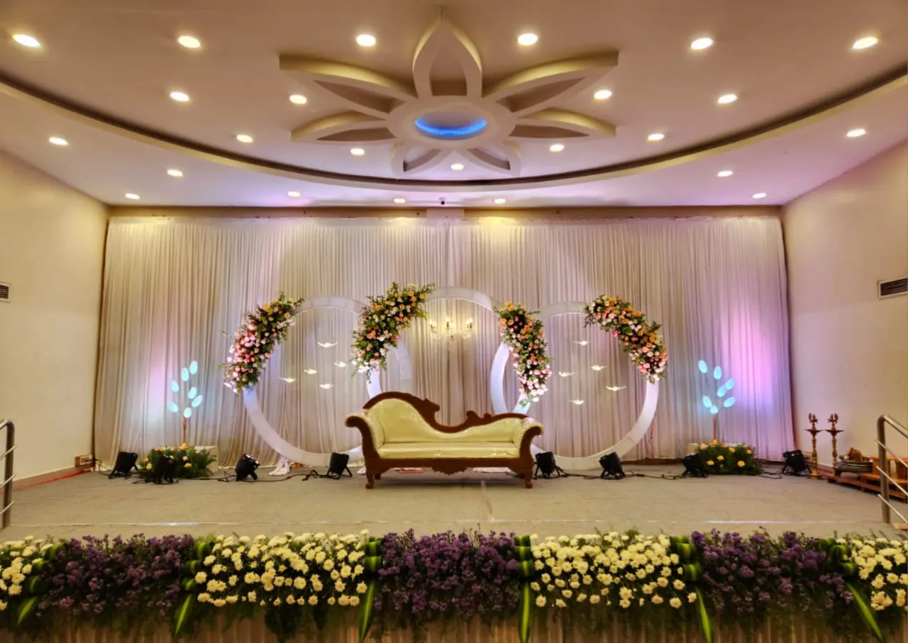 Stage with white floral rings in soft lilac light