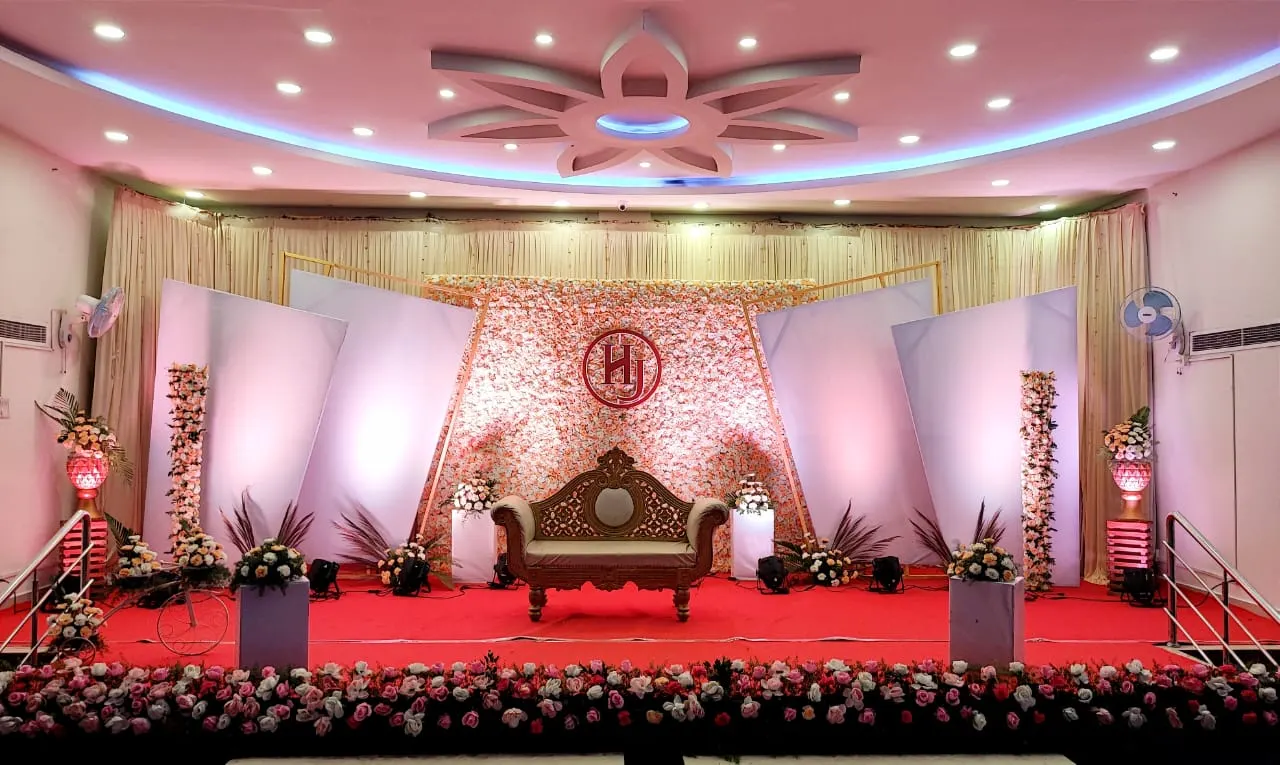 Stage with a carved throne and white flower backdrop